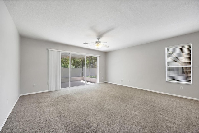 spare room featuring ceiling fan, carpet floors, a textured ceiling, and baseboards