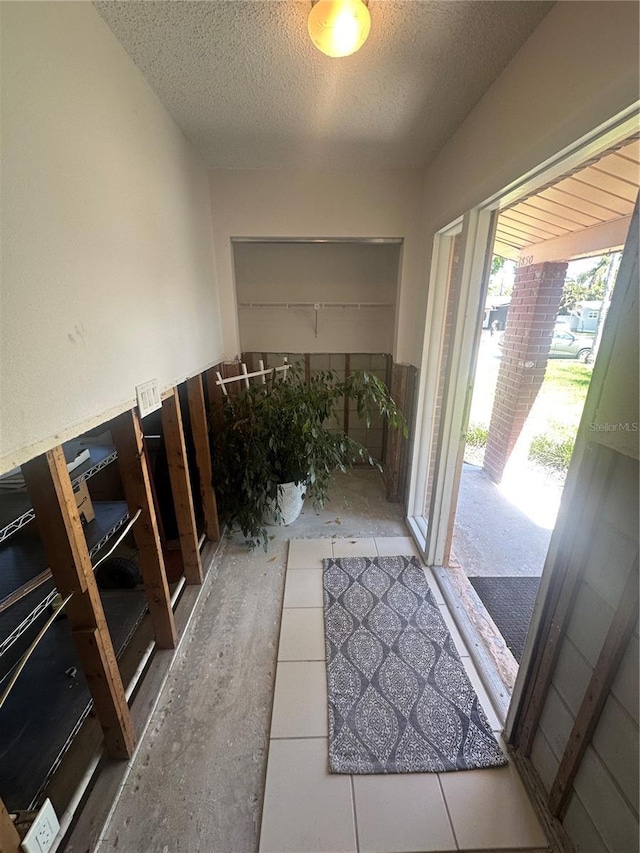 doorway with a textured ceiling