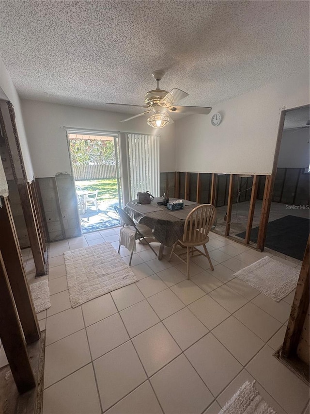 dining area with light tile patterned floors, a textured ceiling, and ceiling fan