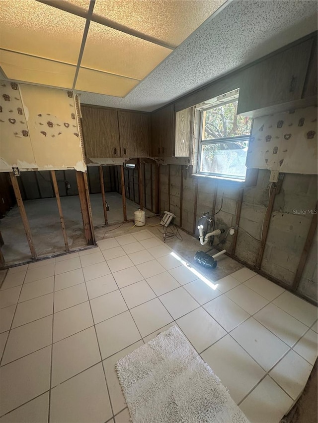 basement featuring light tile patterned floors