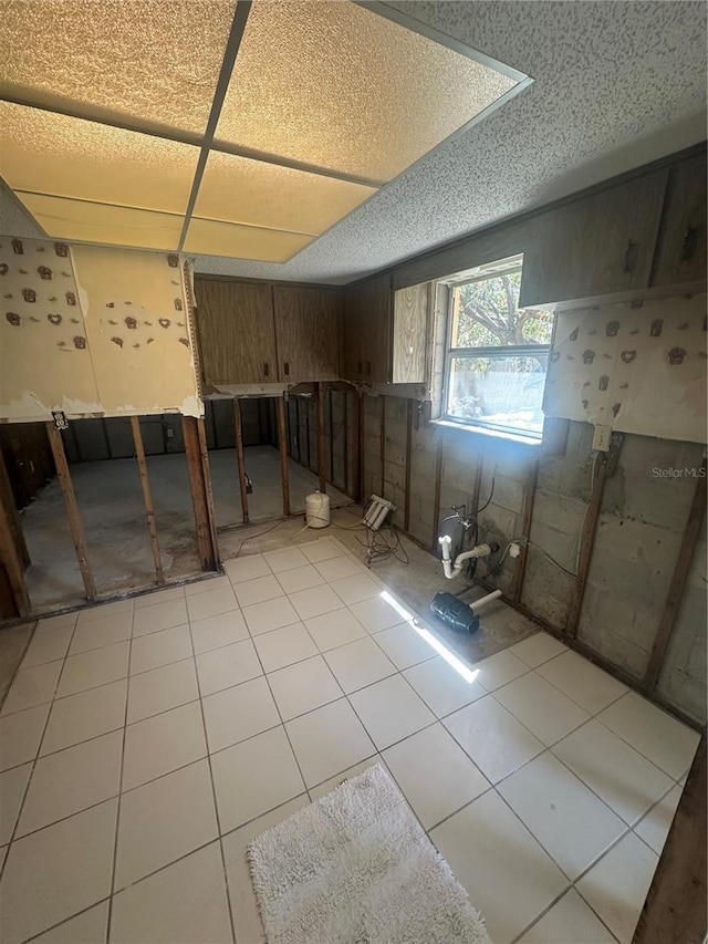 below grade area with light tile patterned floors