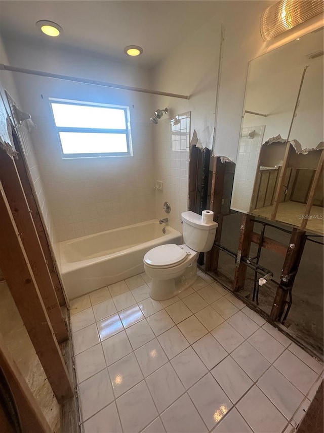 bathroom with toilet, shower / bathtub combination, and tile patterned flooring