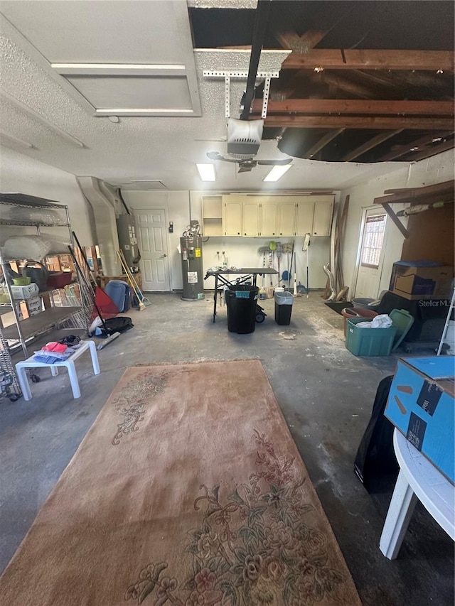 garage featuring electric water heater and a garage door opener