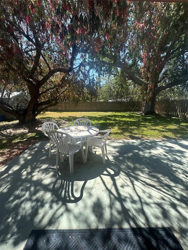 view of patio featuring fence and outdoor dining area