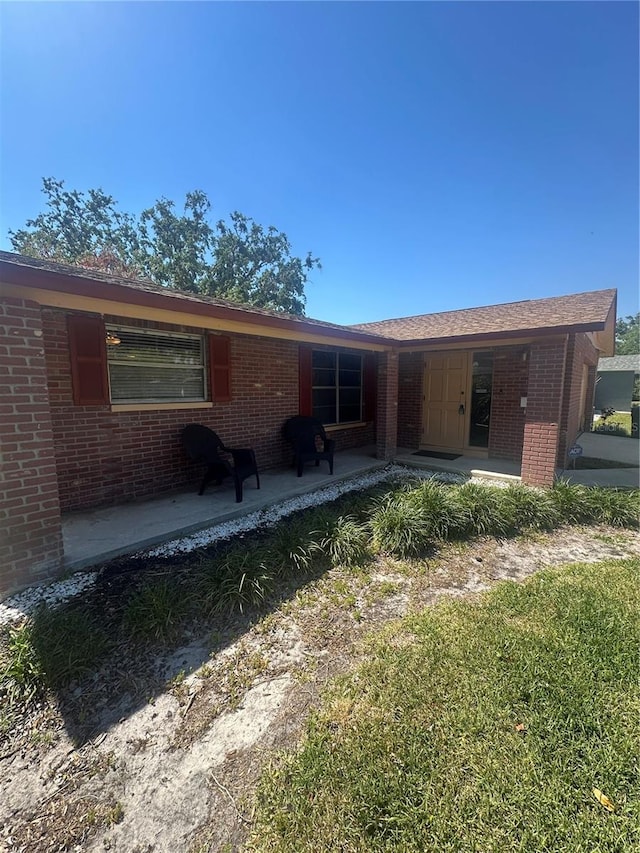 rear view of house with brick siding