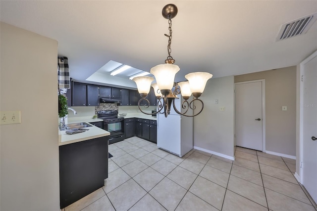 kitchen featuring light countertops, visible vents, black electric range oven, a sink, and a notable chandelier