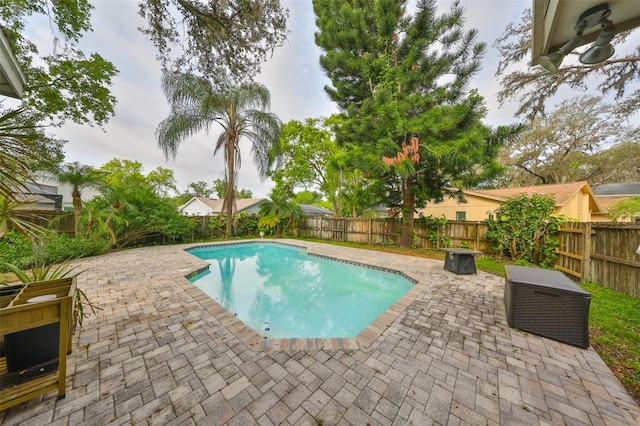 view of pool featuring a fenced backyard and a patio