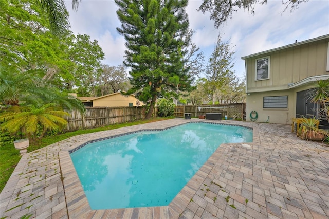 view of swimming pool featuring a fenced backyard, a fenced in pool, and a patio area