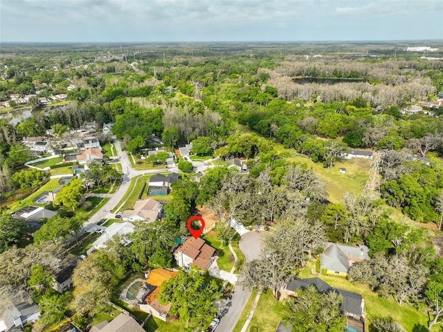 drone / aerial view featuring a residential view and a view of trees