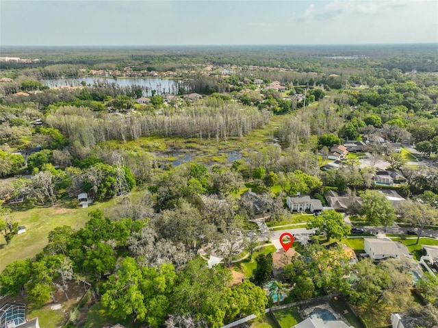 drone / aerial view with a water view and a view of trees