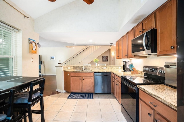 kitchen featuring a sink, black range with electric cooktop, dishwasher, a peninsula, and lofted ceiling