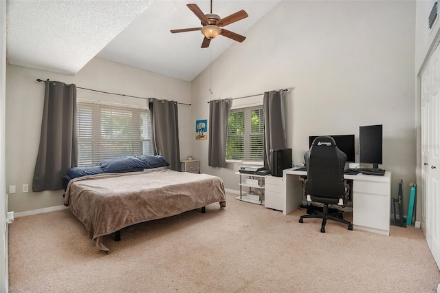 bedroom featuring baseboards, carpet floors, and high vaulted ceiling