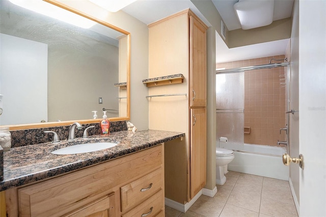 bathroom with bathing tub / shower combination, toilet, baseboards, tile patterned flooring, and vanity