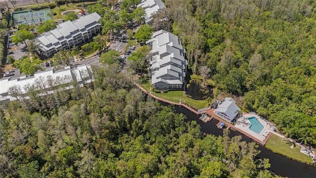 birds eye view of property featuring a view of trees and a water view