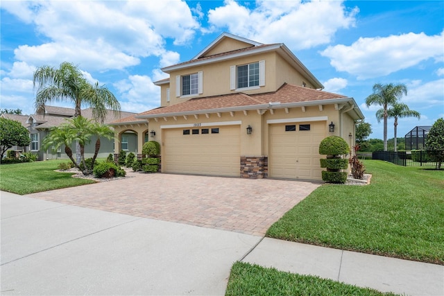 19123 Sunset Bay Dr, Land O Lakes, FL 34638 - view of front of house featuring fence, stucco siding, a front lawn, and decorative driveway