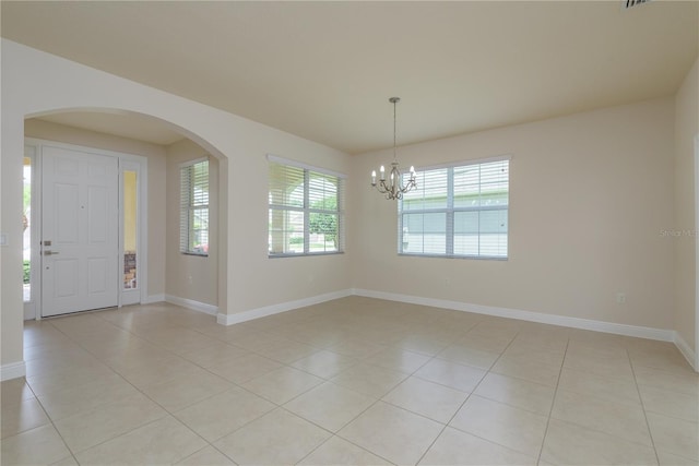 19123 Sunset Bay Dr, Land O Lakes, FL 34638 - interior space with arched walkways, light tile patterned floors, a chandelier, and a healthy amount of sunlight