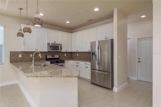 19123 Sunset Bay Dr, Land O Lakes, FL 34638 - kitchen with a peninsula, light tile patterned floors, a sink, backsplash, and stainless steel appliances