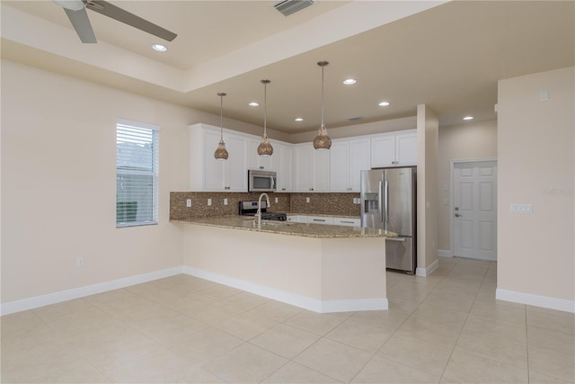 19123 Sunset Bay Dr, Land O Lakes, FL 34638 - kitchen featuring backsplash, visible vents, appliances with stainless steel finishes, light stone countertops, and a peninsula