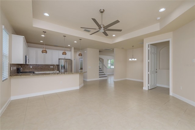 19123 Sunset Bay Dr, Land O Lakes, FL 34638 - kitchen featuring decorative backsplash, recessed lighting, a raised ceiling, ceiling fan with notable chandelier, and stainless steel appliances