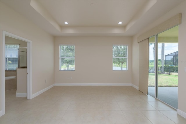 19123 Sunset Bay Dr, Land O Lakes, FL 34638 - unfurnished room featuring light tile patterned floors, baseboards, a tray ceiling, and recessed lighting