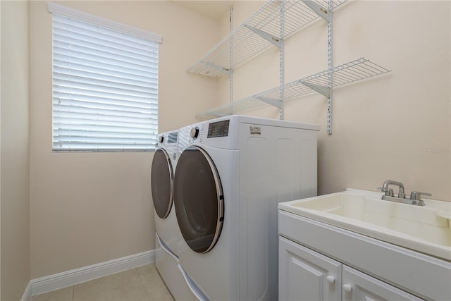 19123 Sunset Bay Dr, Land O Lakes, FL 34638 - clothes washing area with cabinet space, a sink, baseboards, light tile patterned flooring, and washer and dryer