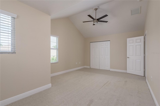 19123 Sunset Bay Dr, Land O Lakes, FL 34638 - unfurnished bedroom featuring light carpet, baseboards, vaulted ceiling, visible vents, and a closet