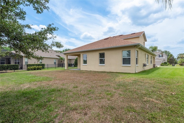 19123 Sunset Bay Dr, Land O Lakes, FL 34638 - back of property featuring a lawn, fence, and stucco siding