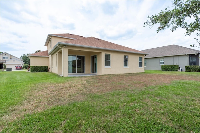 19123 Sunset Bay Dr, Land O Lakes, FL 34638 - back of house featuring a yard, a patio, and stucco siding