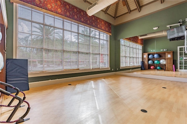 19123 Sunset Bay Dr, Land O Lakes, FL 34638 - workout area featuring visible vents, a high ceiling, and wood finished floors