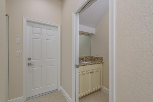 19123 Sunset Bay Dr, Land O Lakes, FL 34638 - doorway with a sink, light tile patterned flooring, baseboards, and indoor wet bar
