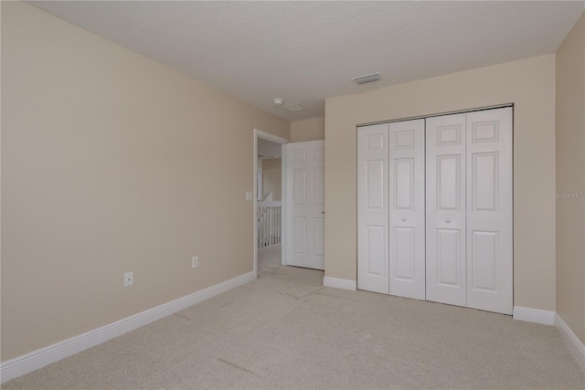 19123 Sunset Bay Dr, Land O Lakes, FL 34638 - unfurnished bedroom with light colored carpet, baseboards, a closet, and visible vents