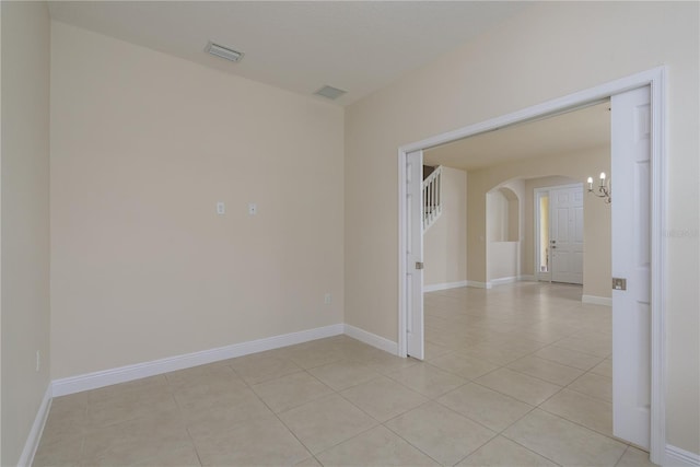 19123 Sunset Bay Dr, Land O Lakes, FL 34638 - spare room with an inviting chandelier, arched walkways, light tile patterned flooring, and visible vents