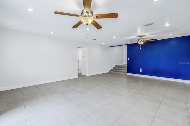 unfurnished room with visible vents, baseboards, ceiling fan, recessed lighting, and stairway
