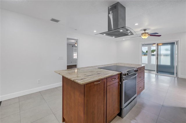 kitchen with stainless steel electric range, island exhaust hood, light stone counters, visible vents, and ceiling fan
