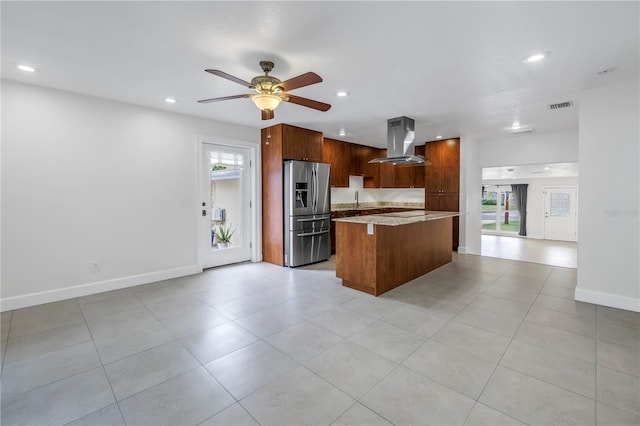 kitchen with visible vents, range hood, recessed lighting, a kitchen island, and stainless steel refrigerator with ice dispenser