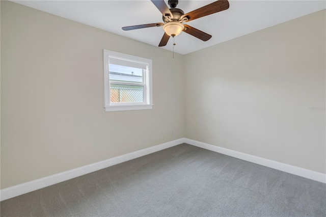 unfurnished room with a ceiling fan, carpet, and baseboards