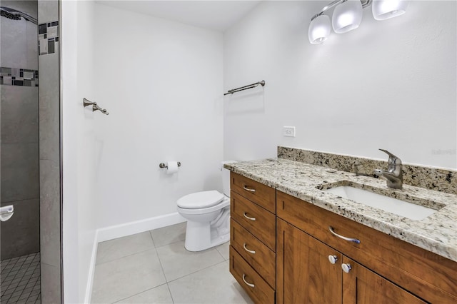 full bath featuring vanity, toilet, baseboards, tile patterned floors, and tiled shower