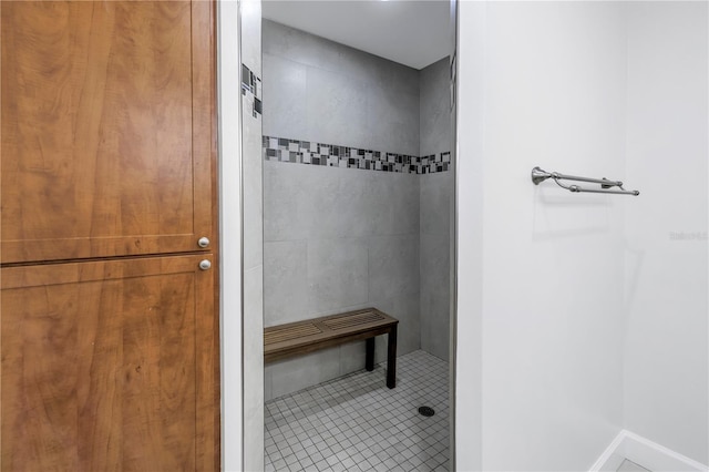 bathroom featuring a tile shower and tile patterned flooring