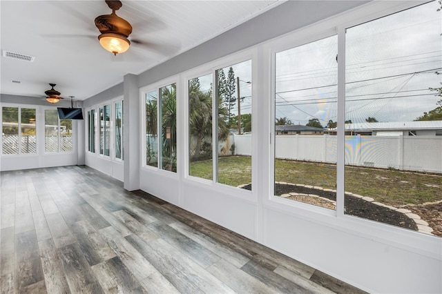 unfurnished sunroom with ceiling fan and visible vents