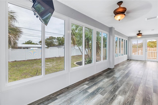 unfurnished sunroom with french doors, wood finished floors, and visible vents