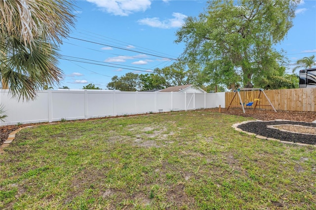 view of yard with a fenced backyard and a playground