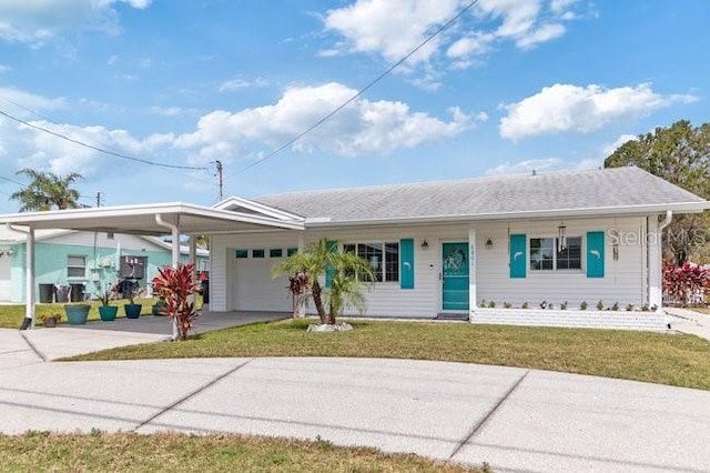 ranch-style home with a garage, a front lawn, driveway, and an attached carport