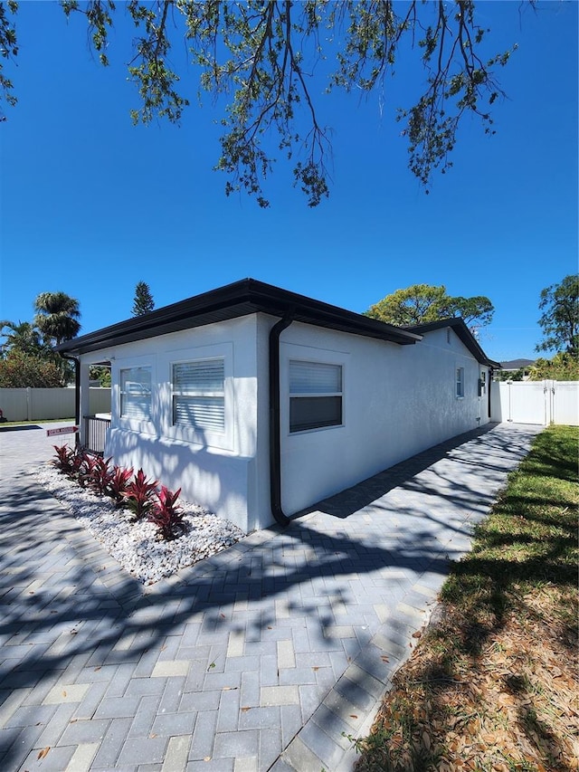 4619 Helena St NE, Saint Petersburg, FL 33703 - view of property exterior with stucco siding and fence