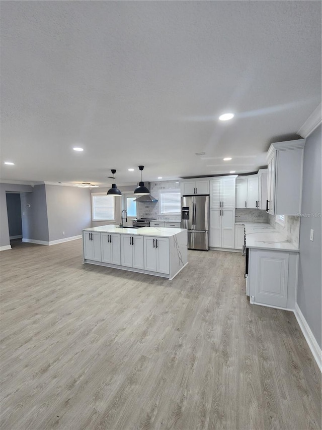 4619 Helena St NE, Saint Petersburg, FL 33703 - kitchen featuring light countertops, backsplash, stainless steel fridge, and light wood-type flooring