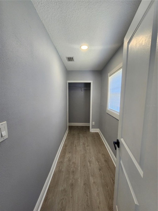 4619 Helena St NE, Saint Petersburg, FL 33703 - corridor featuring baseboards, a textured ceiling, visible vents, and wood finished floors