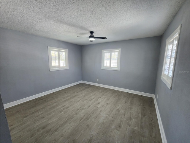 4619 Helena St NE, Saint Petersburg, FL 33703 - unfurnished room featuring a wealth of natural light, ceiling fan, baseboards, and dark wood-type flooring