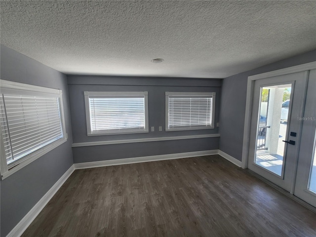 4619 Helena St NE, Saint Petersburg, FL 33703 - spare room featuring a textured ceiling, baseboards, and dark wood finished floors