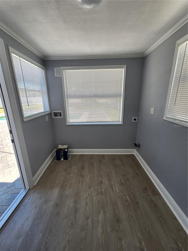 4619 Helena St NE, Saint Petersburg, FL 33703 - empty room featuring dark wood-style flooring, baseboards, and a textured ceiling