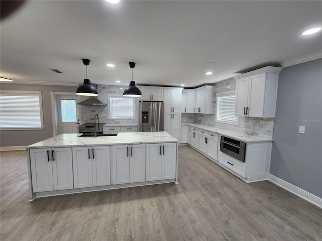 4619 Helena St NE, Saint Petersburg, FL 33703 - kitchen featuring white cabinets, light wood-style floors, backsplash, and stainless steel appliances