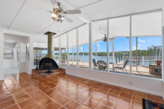 unfurnished sunroom with a wood stove